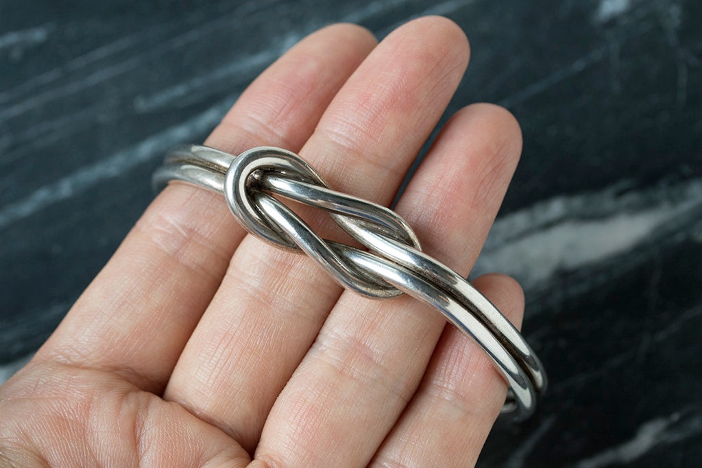 silver knot bangle on hand WEB